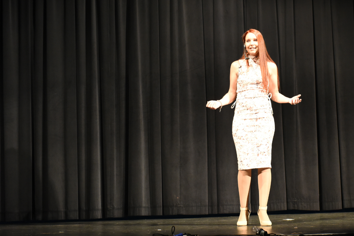 Melissa Wiringi speaking on stage to a live audience